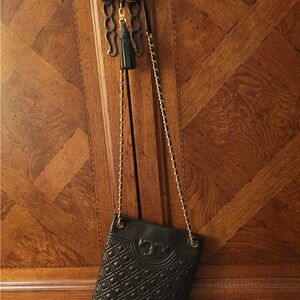 Tory Burch crossbody and yes an IPhone will fit inside